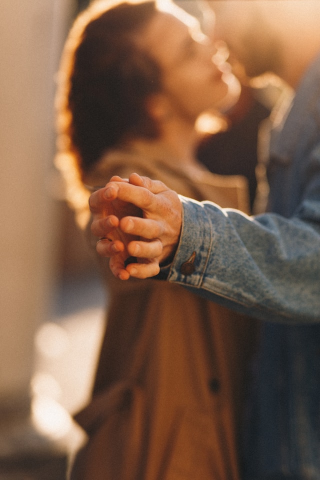 Two people dancing together in warm, golden light